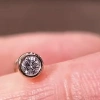 The simple diamond-encrusted stud earrings are versatile details Picture
